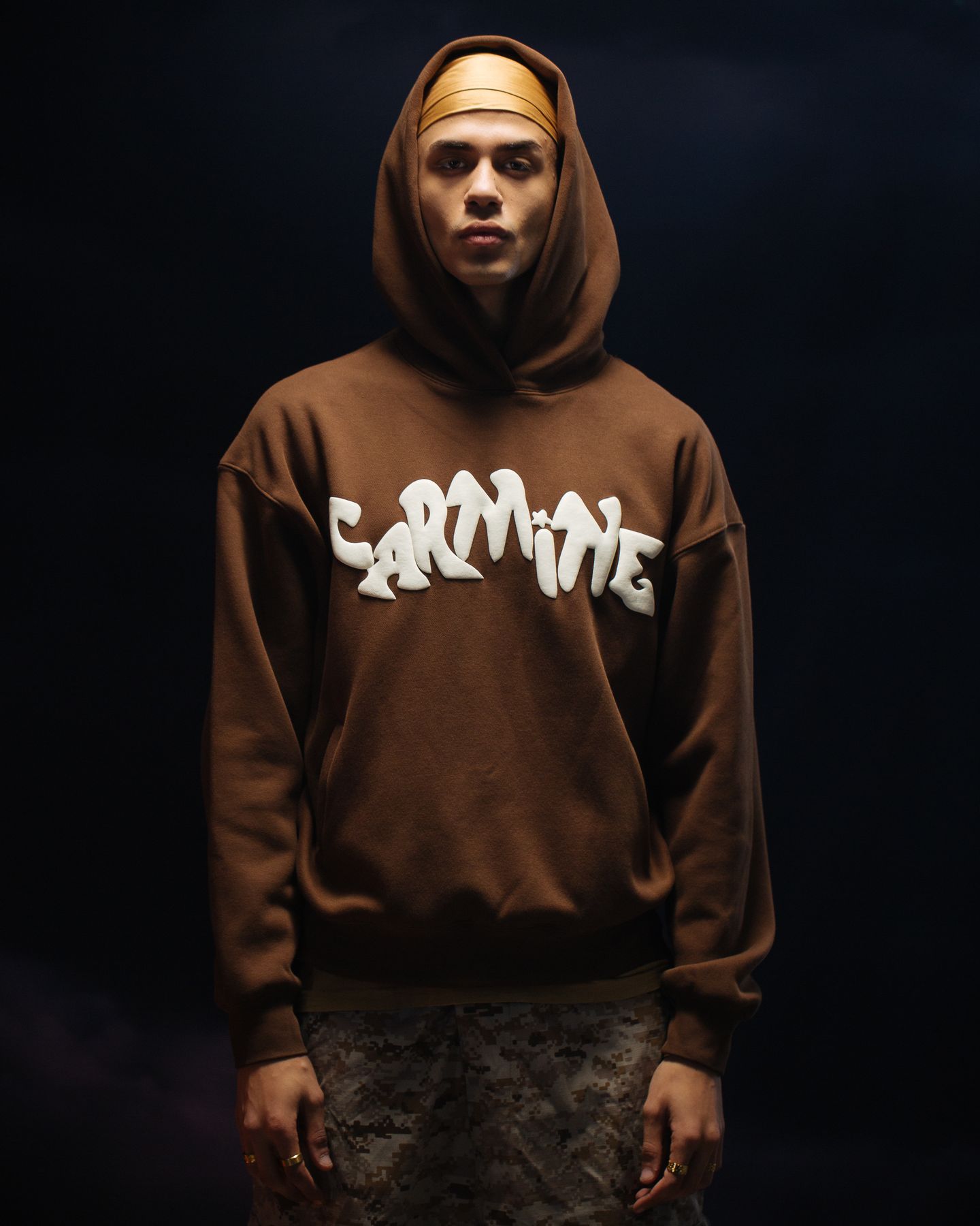 Model in a brown Carmine hoodie