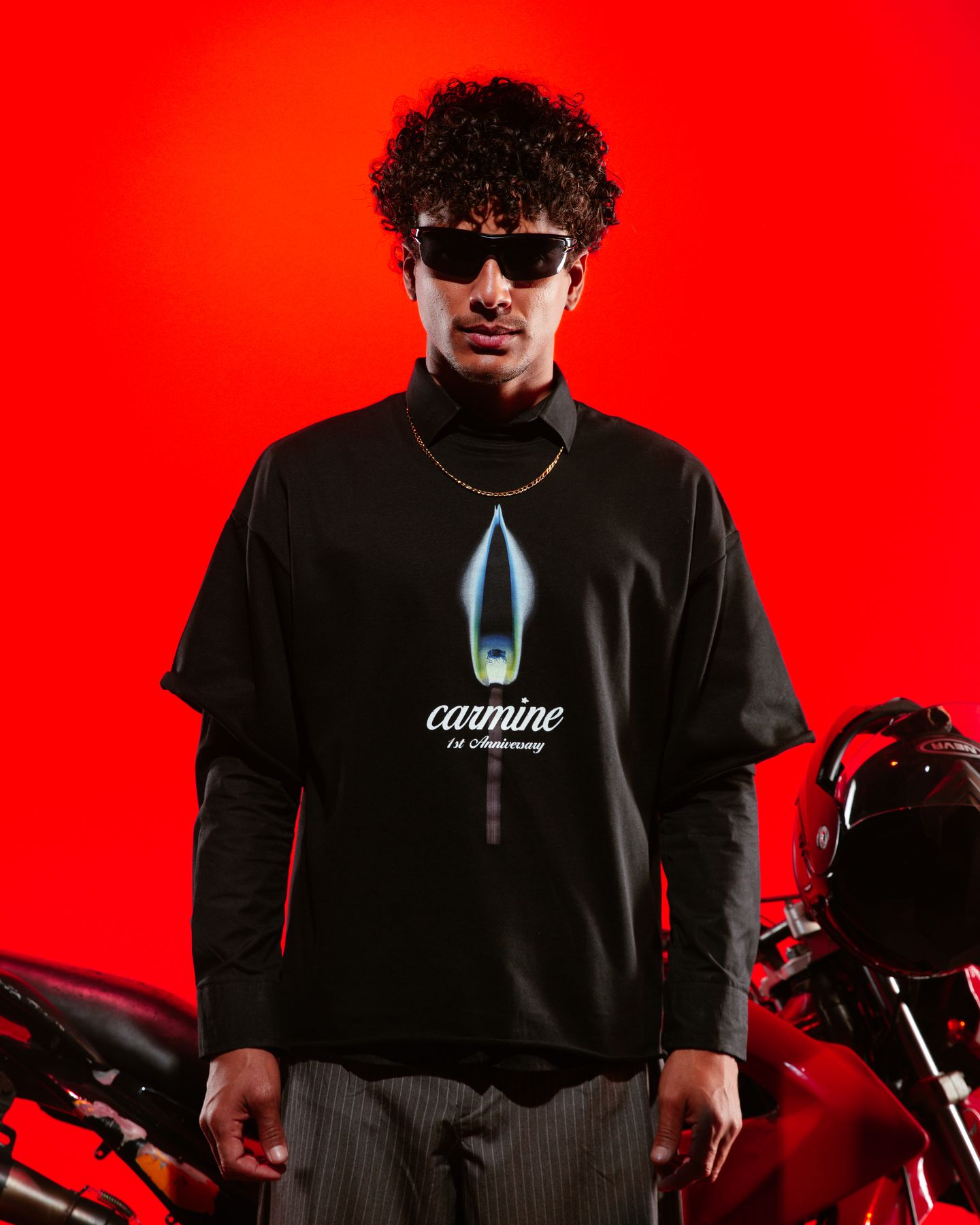 Model in a black Carmine tee beside the motorbike