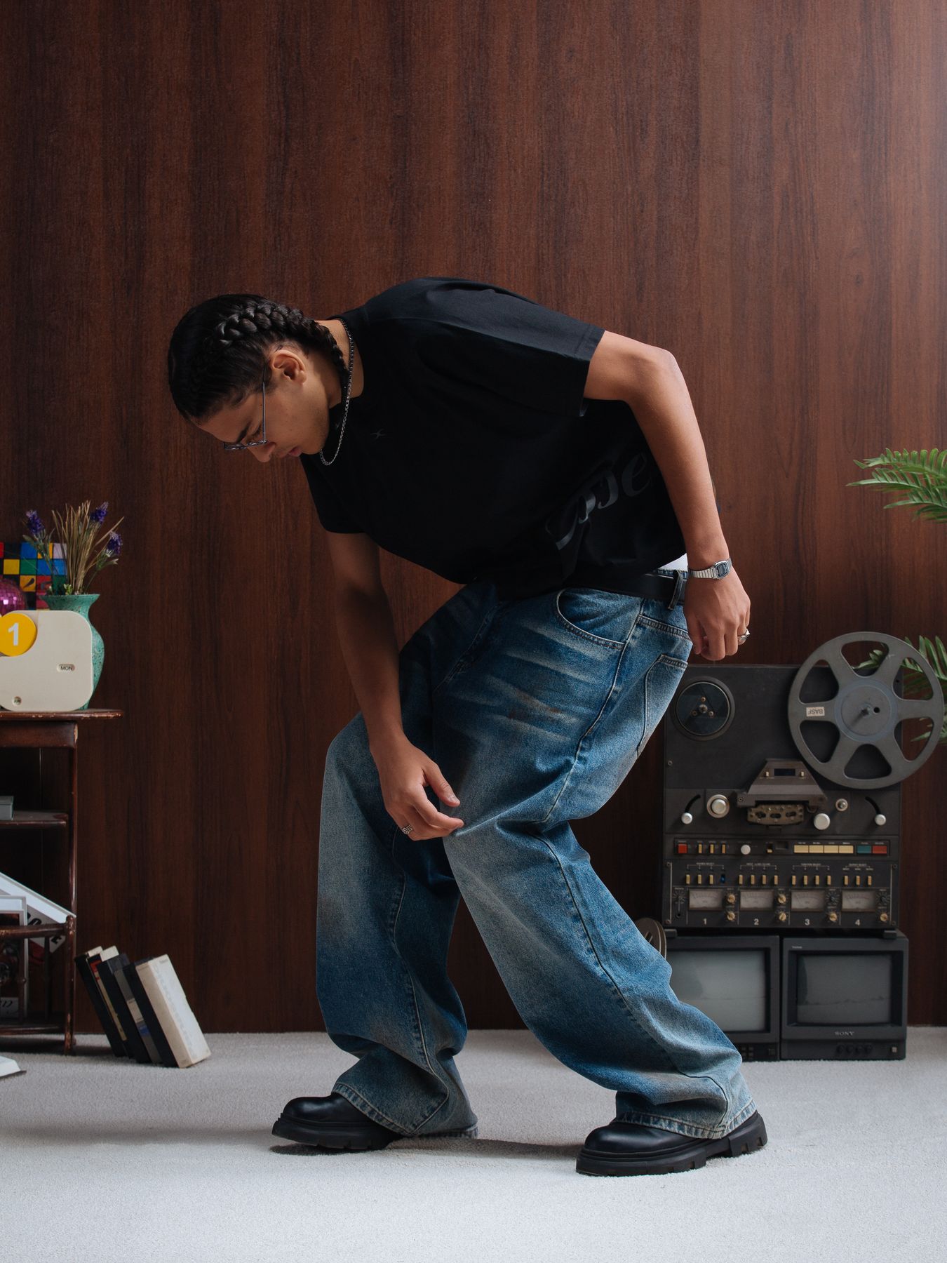 Model bending forward in wide jeans